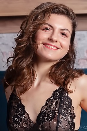 Kassie Smiles Flirtatiously As She Lounges On The Bed In Sexy Lingerie