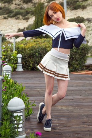 Redhead takes off her miniskirt photo 8