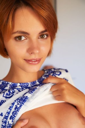 Skinny redhead plays with her tits photo 16